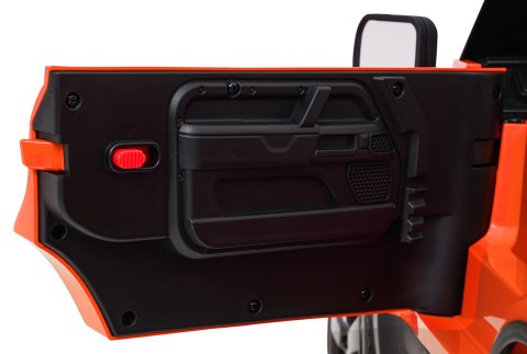 Auto Land Rover Defender pomarańczowe na akumulator dla dzieci + pilot R/C